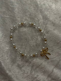 Love Letter white pearl and gold bead bracelet with gold bow charm